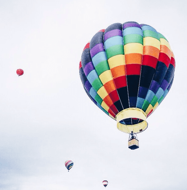 Hot air balloons drifting overhead
